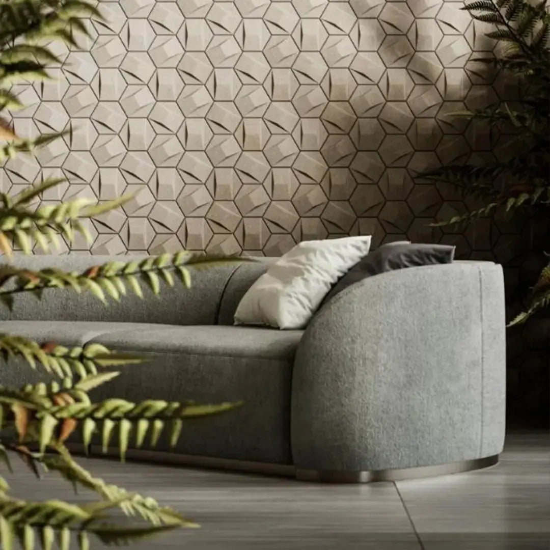 Gray sofa with decorative pillows against a geometric-patterned wall.