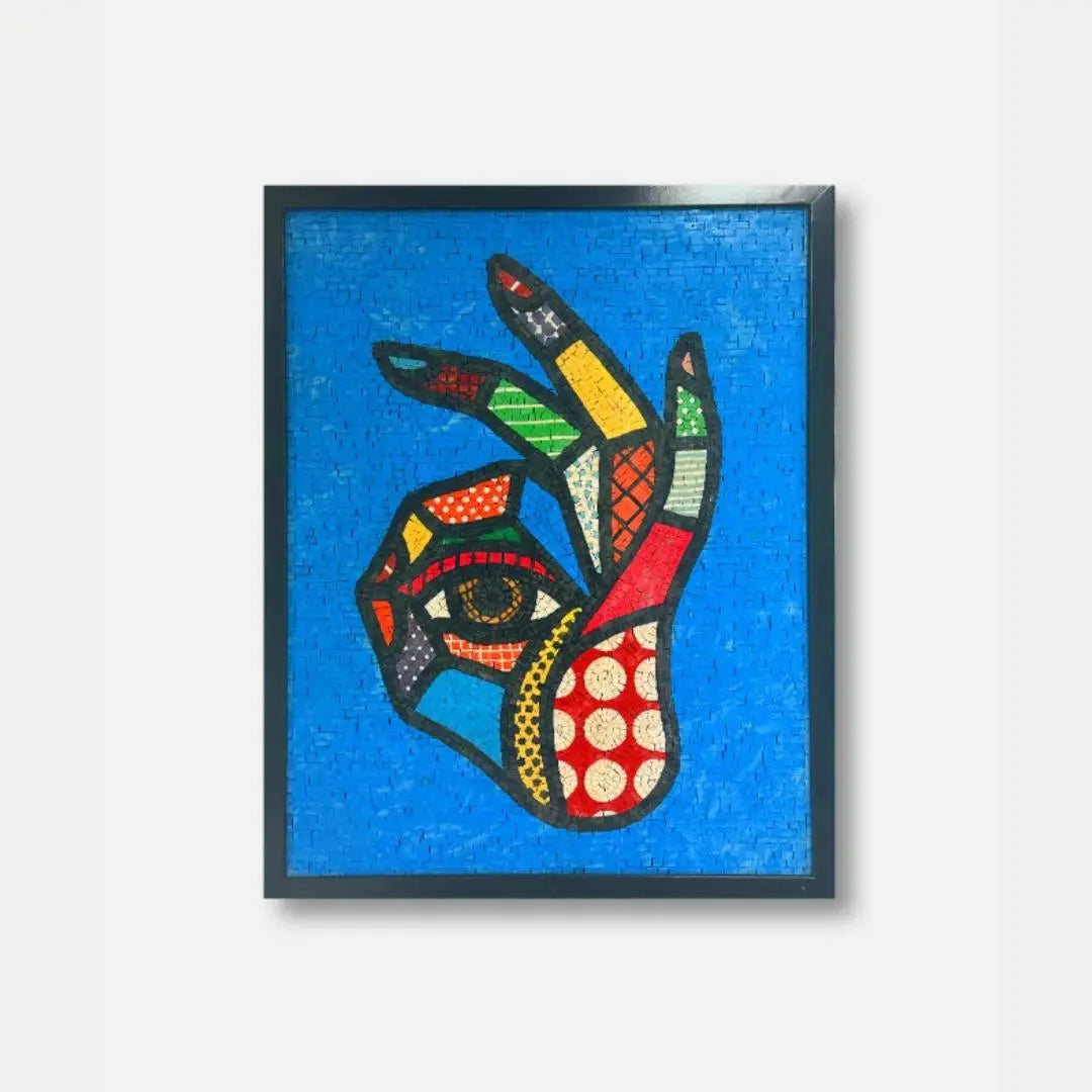Framed artwork of a colorful abstract face on a blue background
