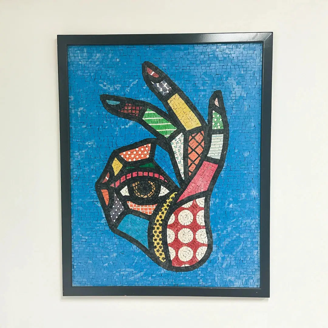 Framed mosaic artwork of a colorful abstract design on a blue background