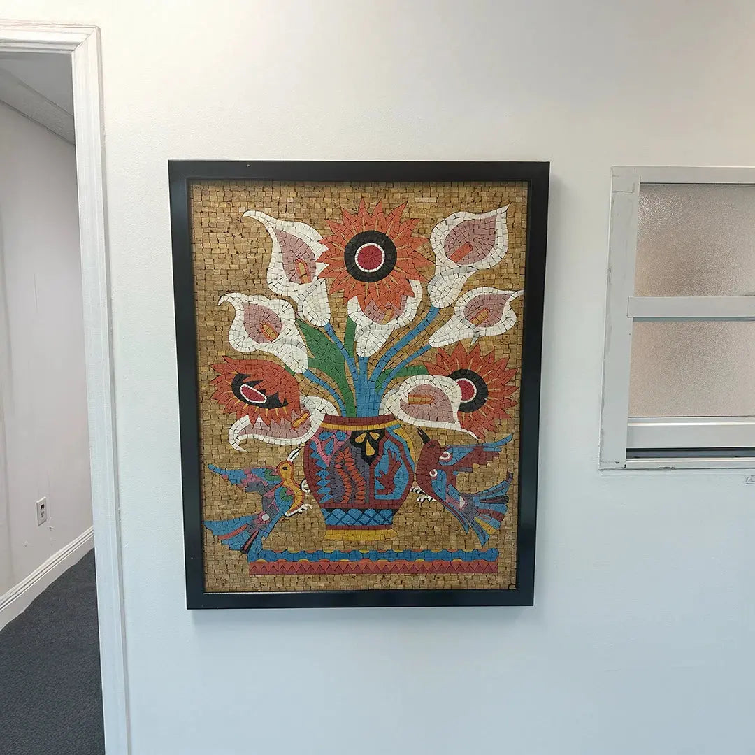 Framed mosaic artwork of flowers on a wall