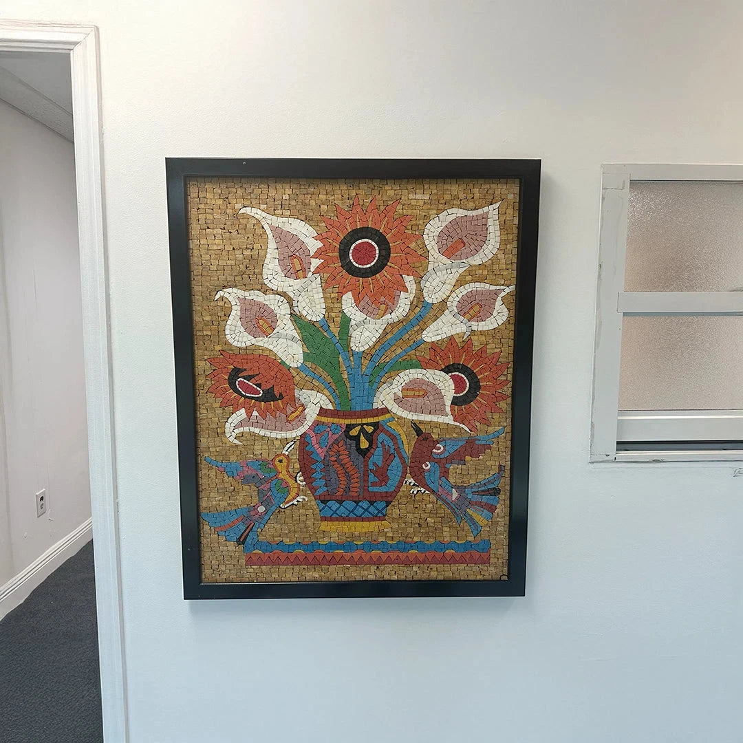 Framed mosaic artwork of flowers on a wall