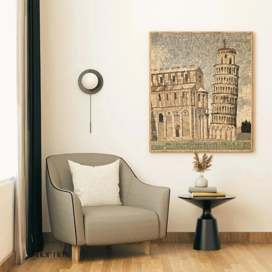 Modern interior with a gray armchair, side table, and artwork of the Leaning Tower of Pisa.