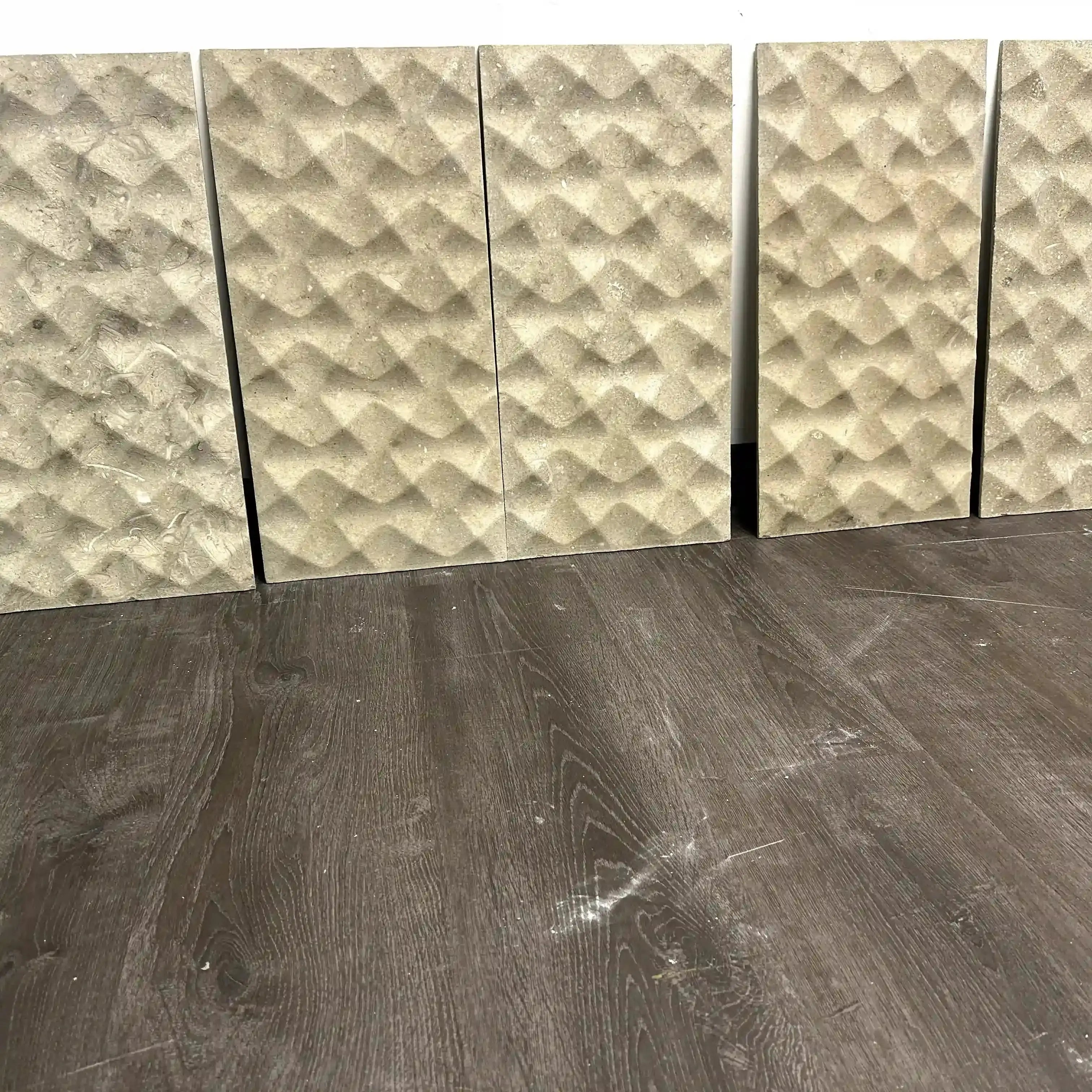 Textured wall panels on a wooden floor