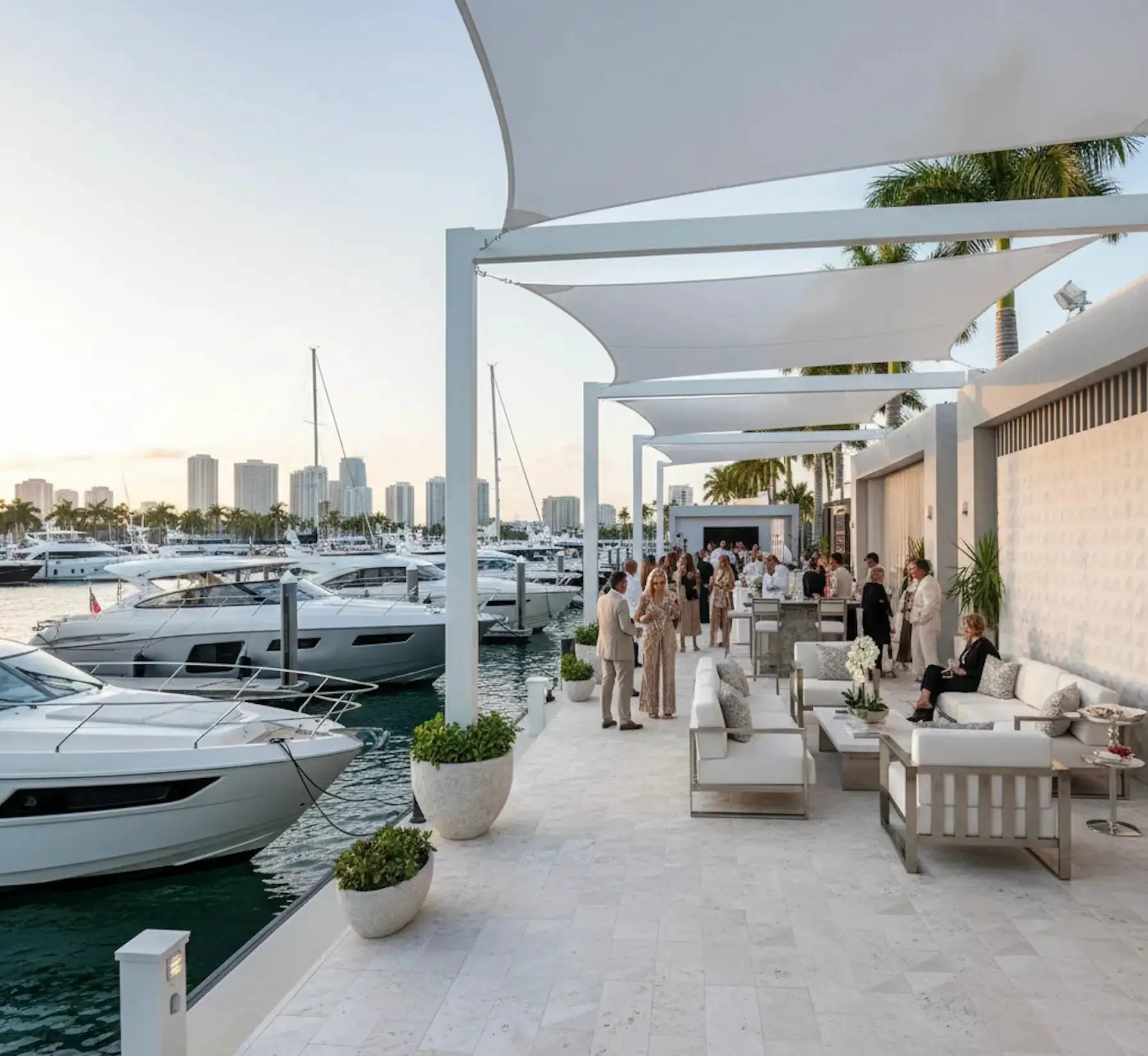 Outdoor marina area with boats, people, and a modern architectural design.