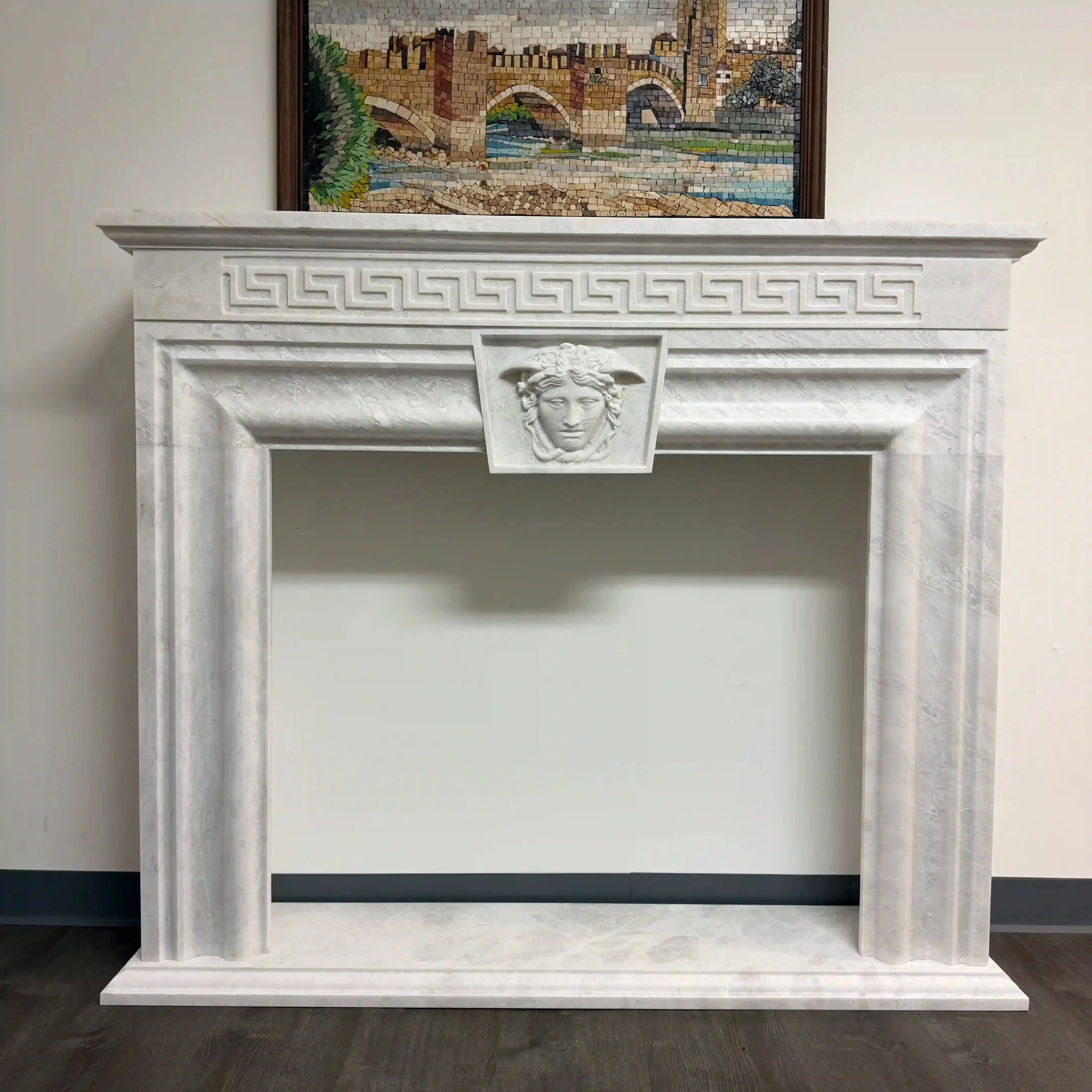 Decorative marble fireplace with classical design elements on a plain wall. misbell