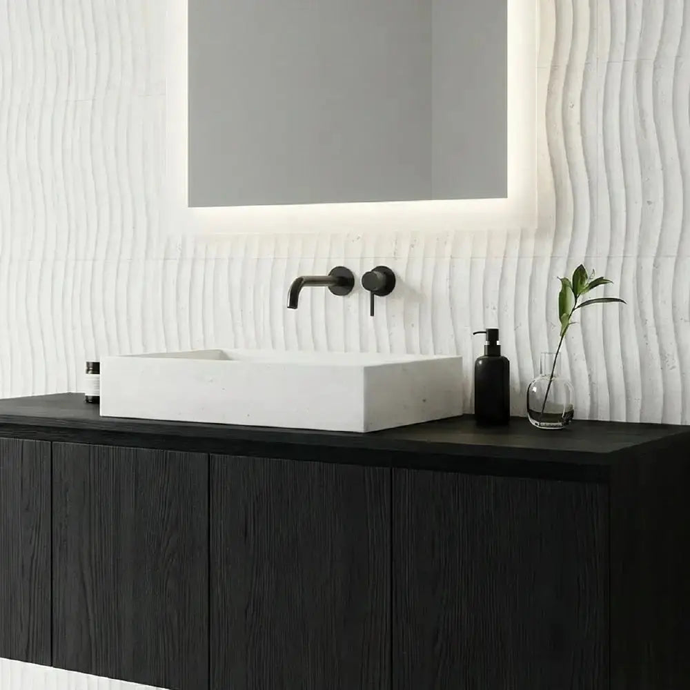 Bathroom vanity with black cabinet, white sink, and decorative wall. bathroom- wall - kitchen - floor installation near me location -corte de laja
losas grandes de pizarra
venta de piedra
camino de piedra natural
