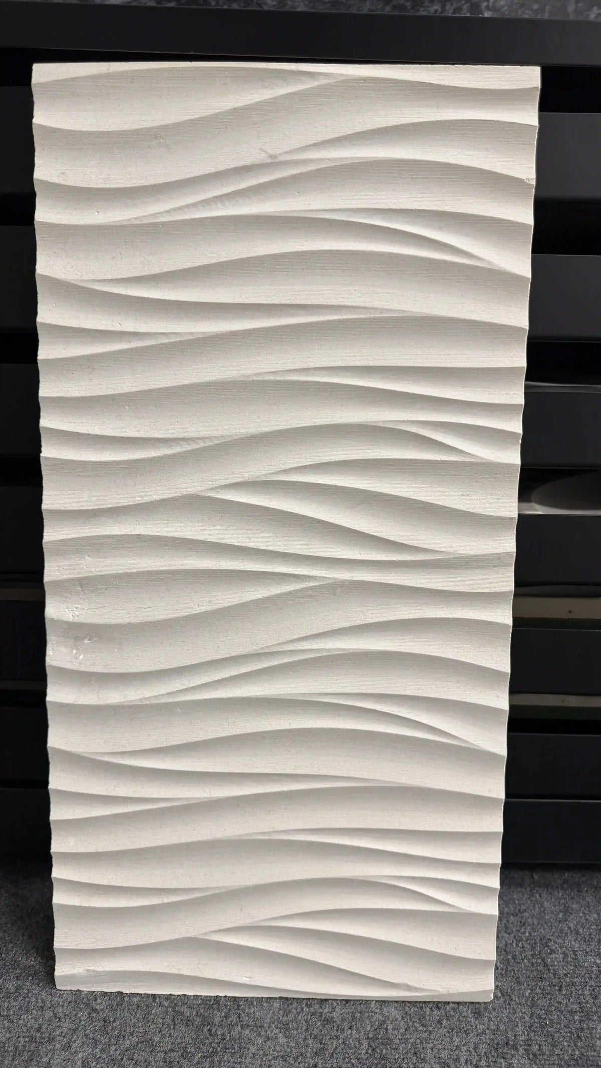 Medea natural stone 3D wall panel featuring fluid, horizontal wavy ridges with a smooth, clean off-white or light stone finish.