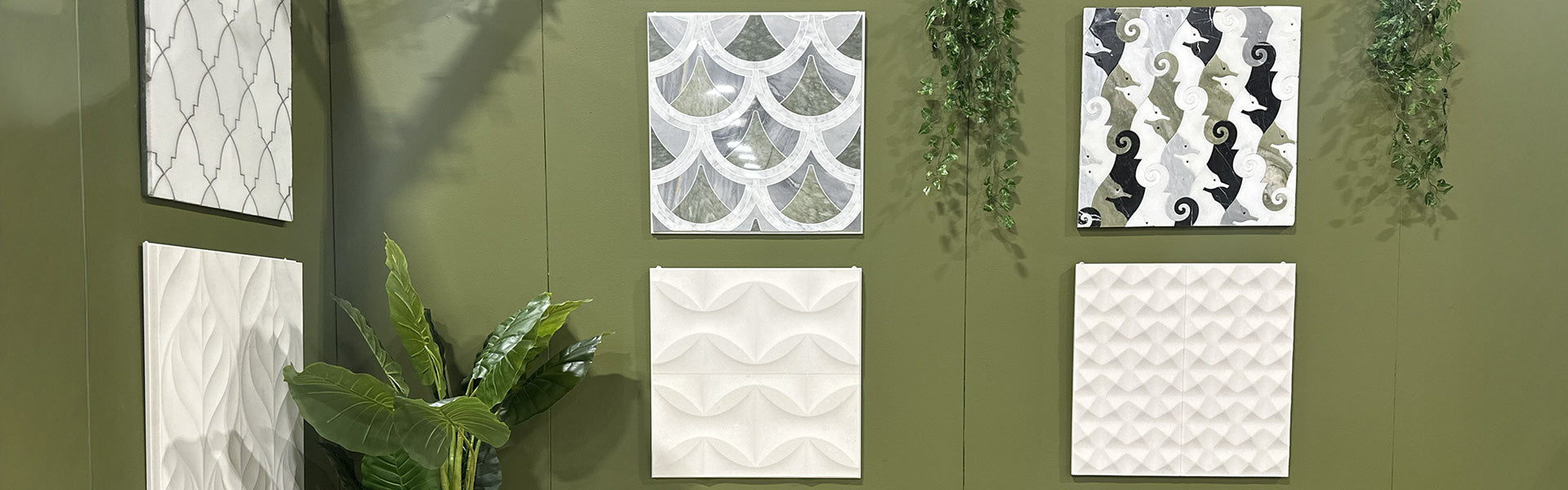 Decorative wall tiles with geometric patterns on a green wall.