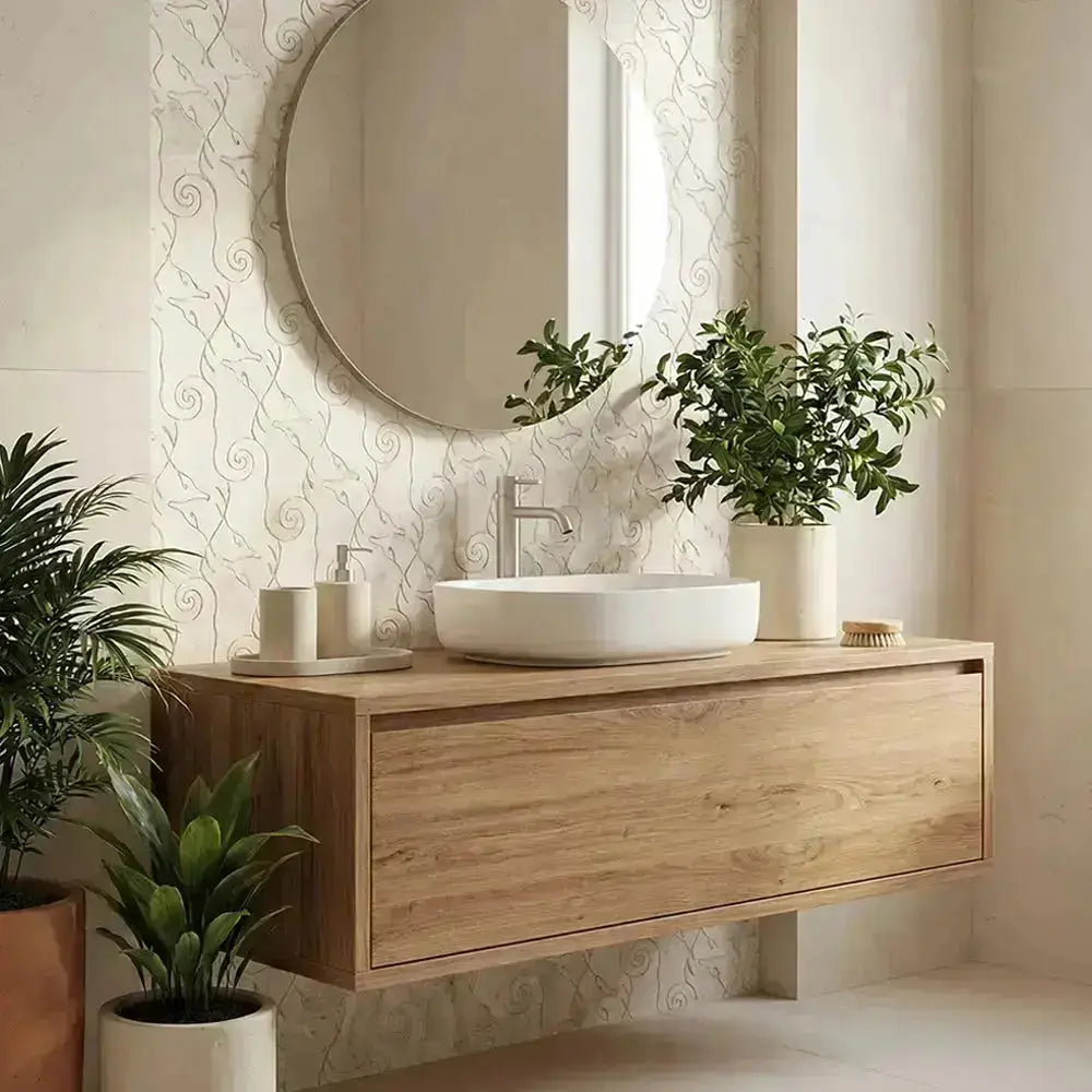 Bathroom vanity with round mirror, plants, and decorative wallpaper.