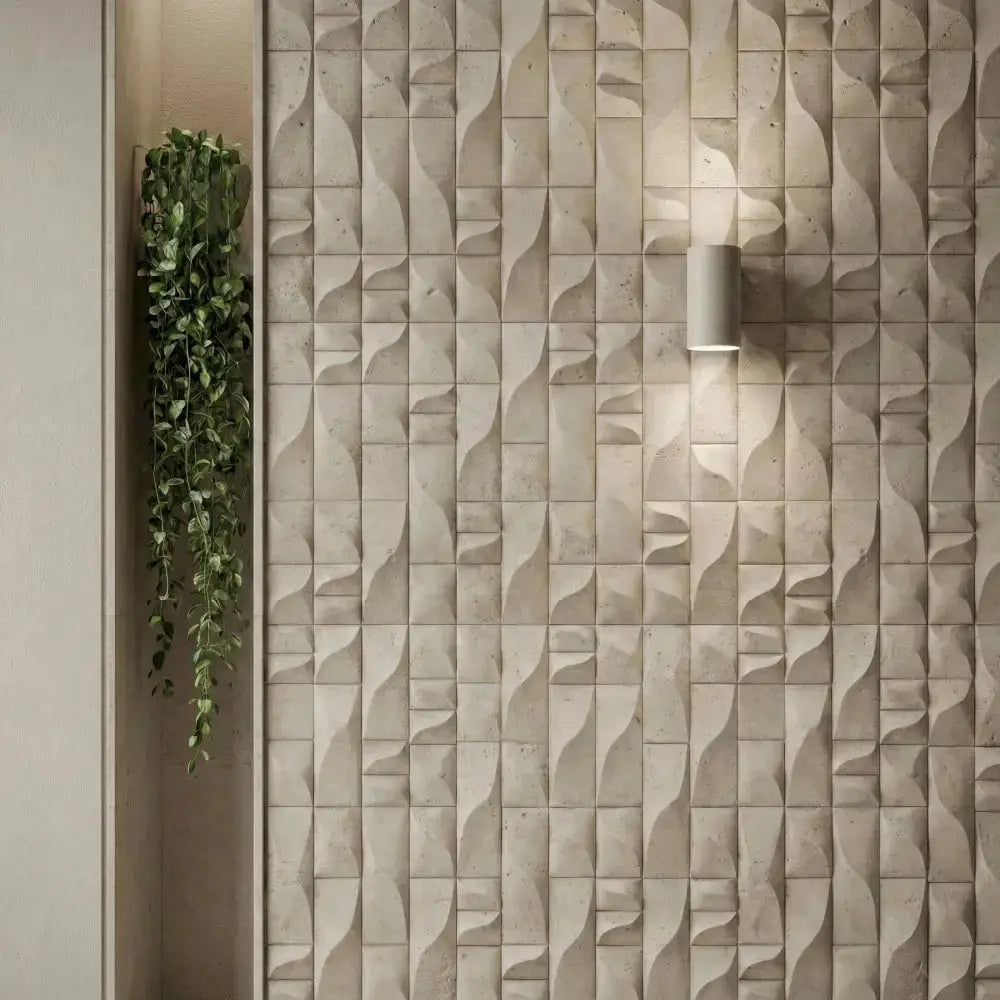 The Sienna 3D wall panel has been applied to the entire wall. A stylish wall sconce is mounted above it. Next to it, a vibrant green plant has been hung, adding a natural touch to the space.