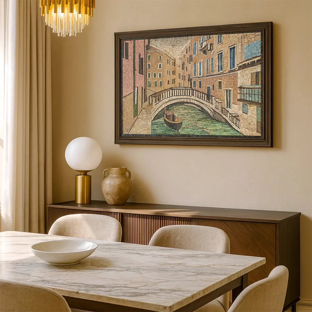 Dining room with marble table, chairs, and a framed painting of a canal scene on the wall.