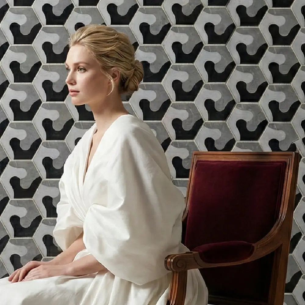 Woman in a white robe sitting on a chair against a geometric patterned wall. tile inc
regrouting
floors and walls
universal tile
laying tile
tile center
quality tile 
the tile shop near me -misbell