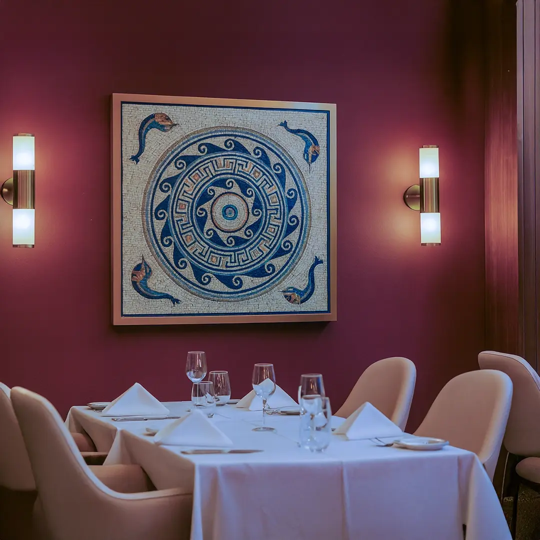 Dining area with a table set for four, chairs, and a decorative wall art piece.