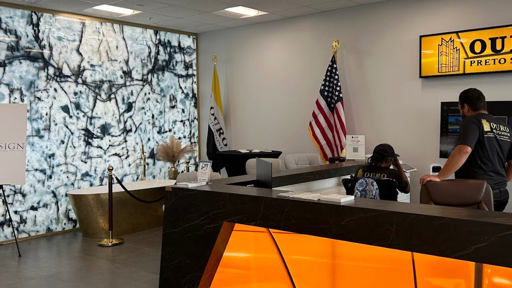 Modern office interior with a reception desk, American flag, and digital display.