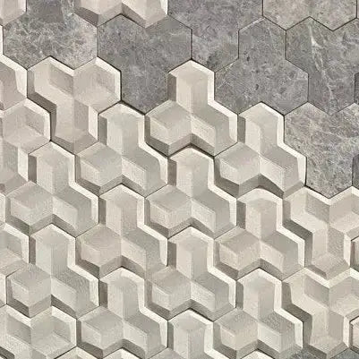 A close-up view of 3D wall tiles arranged in an interlocking, multi-dimensional pattern, featuring a textured light-toned lower section transitioning into smooth dark grey marble tiles at the top.